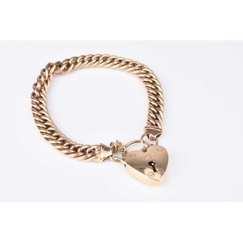 72 - A yellow metal curb link bracelet with heart shaped padlock clasp, stamped '9ct', weight approx 27.9... 