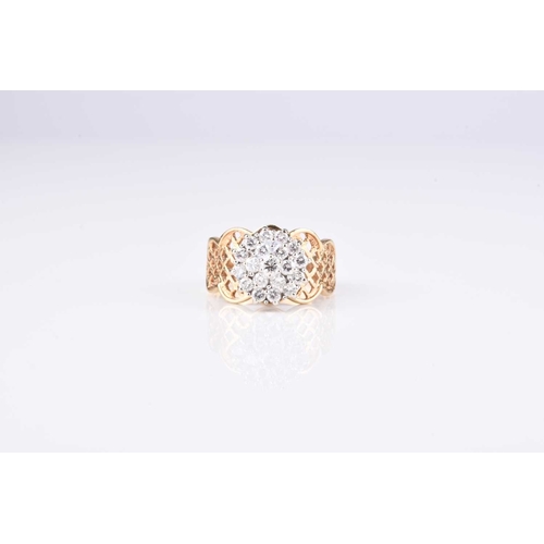 86 - A diamond circular cluster ring, the brilliant cut diamonds claw set in white metal and mounted to d... 