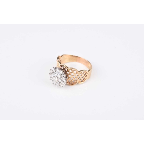 86 - A diamond circular cluster ring, the brilliant cut diamonds claw set in white metal and mounted to d... 