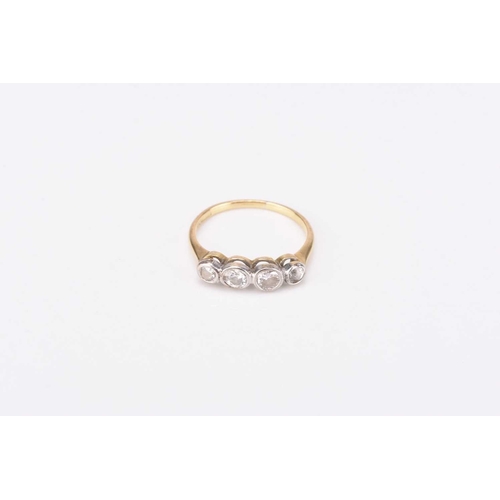 96 - A graduated four stone diamond ring, the brilliant cut diamonds collet set in white metal to yellow ... 