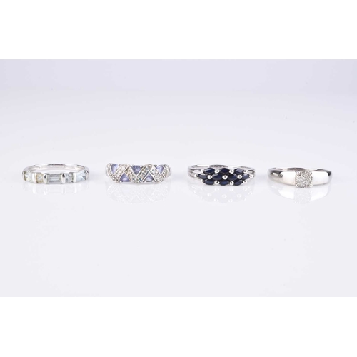 97 - A collection of four 9ct white gold stone set rings, comprising; a diamond cluster example, size S, ... 