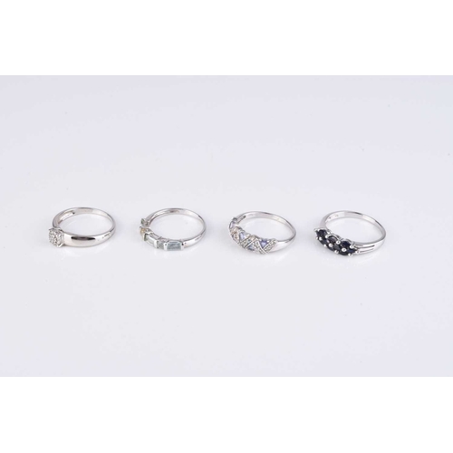 97 - A collection of four 9ct white gold stone set rings, comprising; a diamond cluster example, size S, ... 