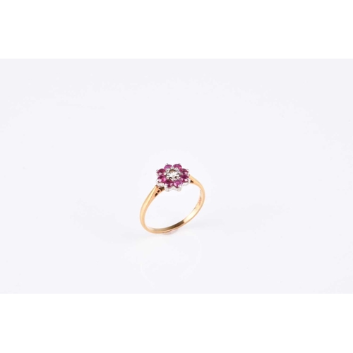 99 - A ruby and diamond floral cluster ring, size L, the yellow metal shank stamped 'plat 18ct', weight a... 