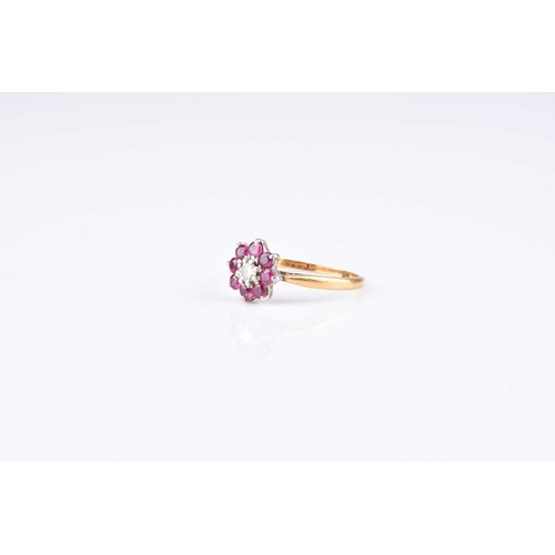 99 - A ruby and diamond floral cluster ring, size L, the yellow metal shank stamped 'plat 18ct', weight a... 