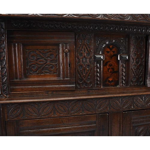 36 - A 17th century and later English oak court cupboard The top section comprising a projecting carved c... 