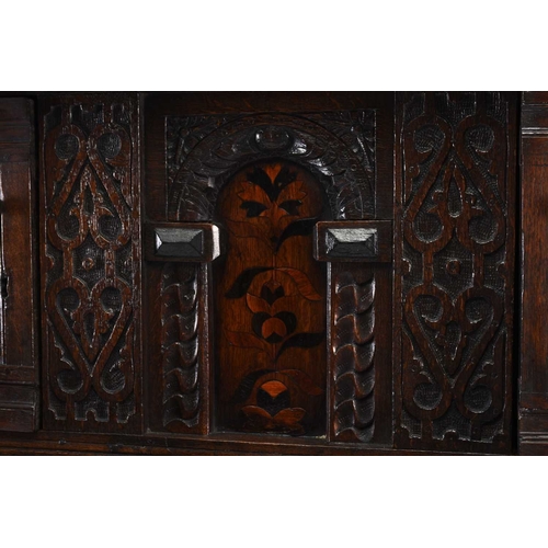 36 - A 17th century and later English oak court cupboard The top section comprising a projecting carved c... 