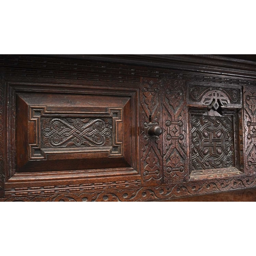 37 - A 17th century oak court cupboard The top rail carved with strapwork and a central monogram RMB and ... 