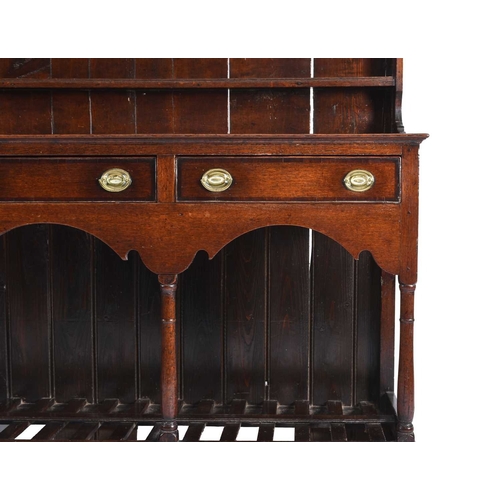 40 - An 18th century oak dresser and rack, South Wales With a three-tier graduated plate rack with openwo... 