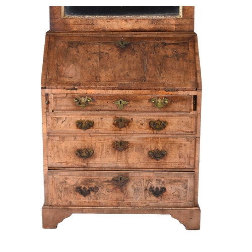 42 - A George II feather-banded walnut bureau cabinet The top cabinet, probably associated, with a single... 