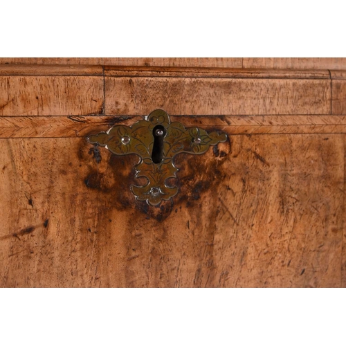 42 - A George II feather-banded walnut bureau cabinet The top cabinet, probably associated, with a single... 