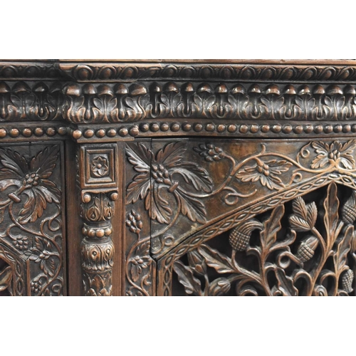 53 - An Anglo-Indian carved rosewood cabinet, 19th century The top with pierced gallery back carved with ... 