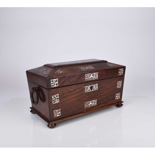 55 - A Victorian rosewood tea caddy Of sarcophagus form with twin ring handles, inlaid with mother-of-pea... 