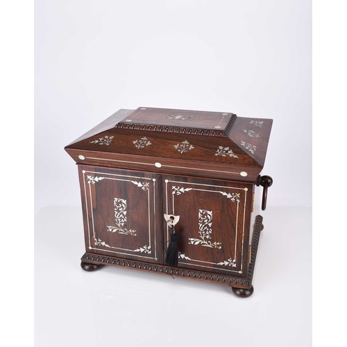 58 - A Victorian inlaid rosewood sewing box Of sarcophagus form with twin ring 'handles', inlaid with mot... 