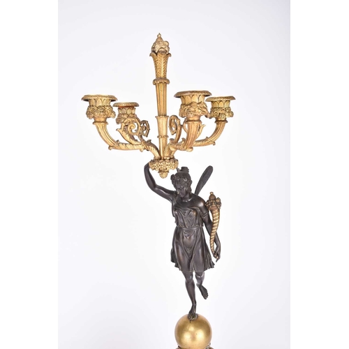 61 - A pair of French parcel gilt bronze figural candelabra Circa 1900 Each with a winged classical figur... 