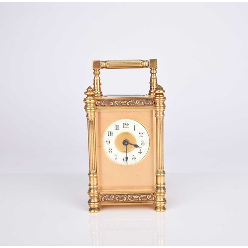 66 - A French early 20th century gilt brass carriage timepiece The circular enamel dial with Arabic hours... 