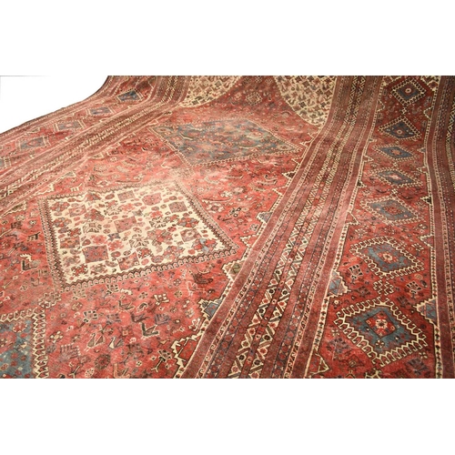 67 - A large Khamseh 'chicken' carpet Late 19th / early 20th century With multiple blue and beige geometr... 