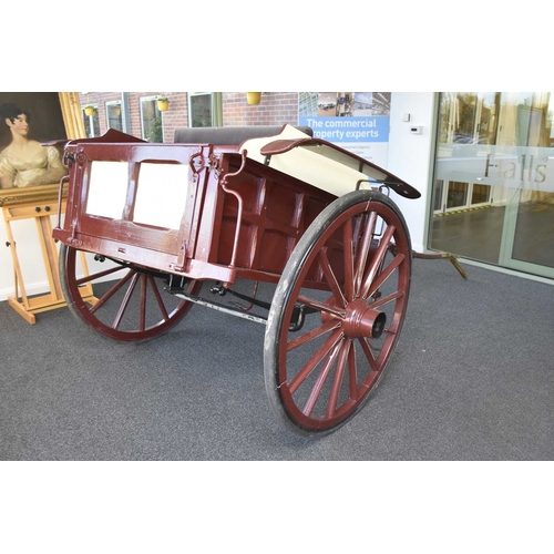 69 - A horse-drawn gig, early 20th century Painted burgundy with cream coachlining, solid body with rear ... 