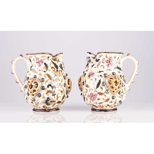 106 - A pair of Zsolnay Pecs jugs, circa 1882-5, decorated with flowers in the Magyar-Turkish style, with ... 