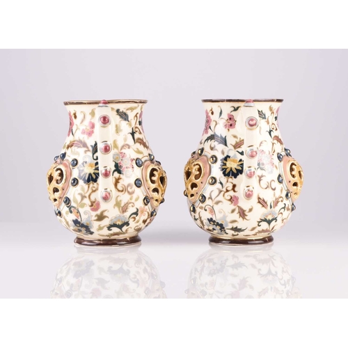 106 - A pair of Zsolnay Pecs jugs, circa 1882-5, decorated with flowers in the Magyar-Turkish style, with ... 