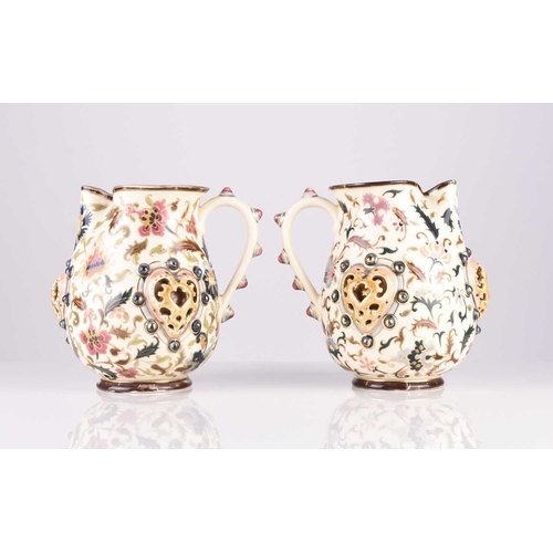 106 - A pair of Zsolnay Pecs jugs, circa 1882-5, decorated with flowers in the Magyar-Turkish style, with ... 