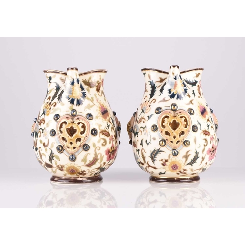 106 - A pair of Zsolnay Pecs jugs, circa 1882-5, decorated with flowers in the Magyar-Turkish style, with ... 