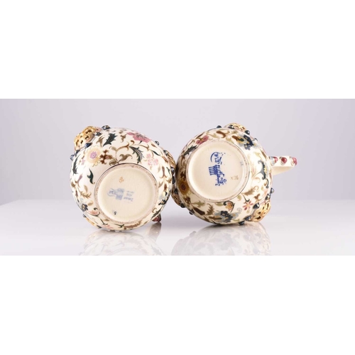 106 - A pair of Zsolnay Pecs jugs, circa 1882-5, decorated with flowers in the Magyar-Turkish style, with ... 