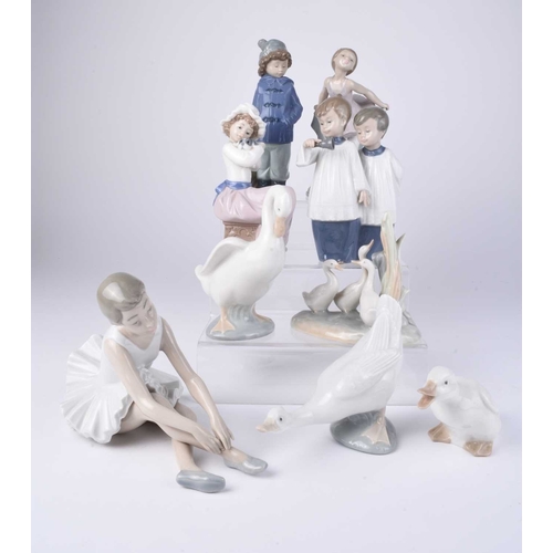 109 - A collection of Lladro and Nao figures, late 20th/early 21st century, including a woman in a shawl h... 