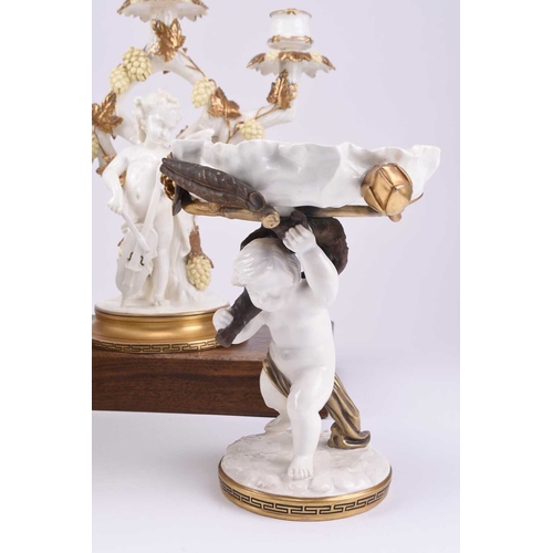 38 - A group of Moore Brothers pottery, late 19th century: A figural candelabra in the form of a cherub w... 