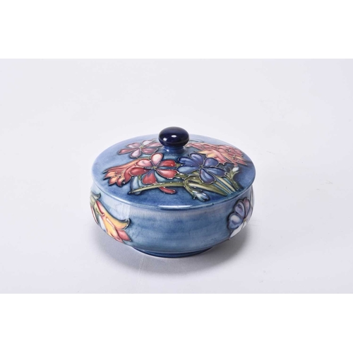 64 - A William Moorcroft 'Spring Flowers' circular powder bowl and cover, circa 1950-60, tubelined with f... 