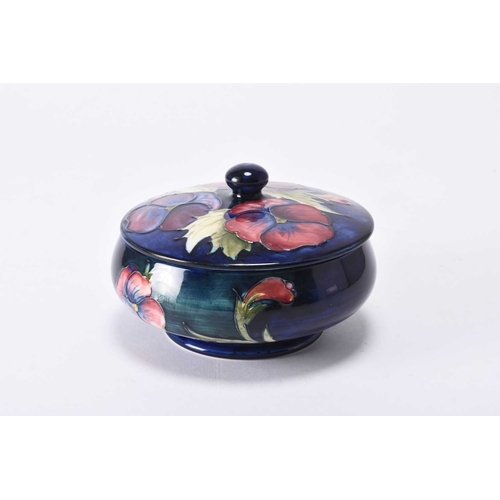 66 - A William Moorcroft large circular powder bowl and cover in the 'Pansy' pattern, circa 1960s/70s, tu... 