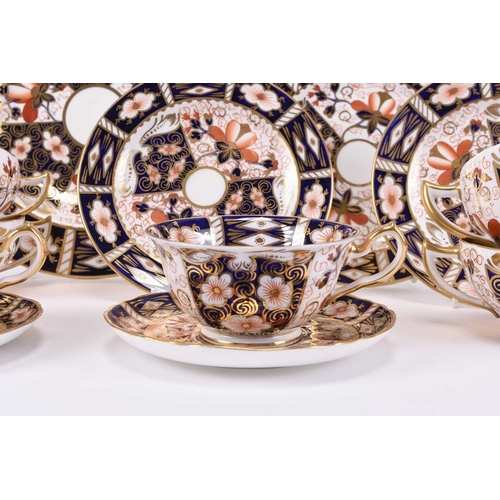 77 - A group of Royal Crown Derby imari dinnerwares, pattern 2451, comprising nine twin-handled soup coup... 