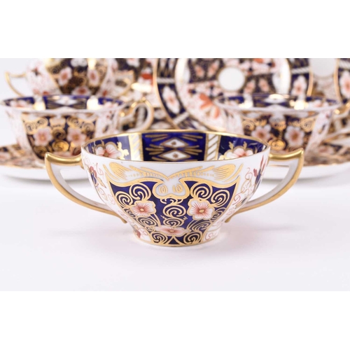 77 - A group of Royal Crown Derby imari dinnerwares, pattern 2451, comprising nine twin-handled soup coup... 