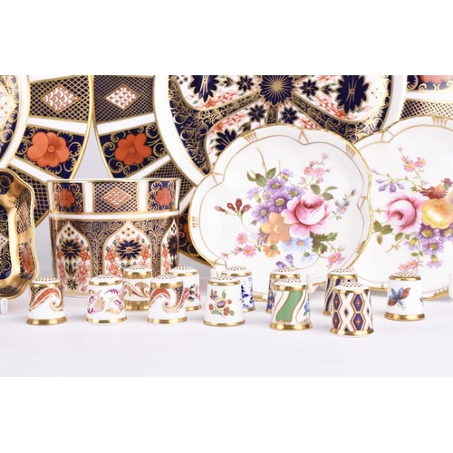 79 - A group of Royal Crown Derby, comprising a set of fifteen thimbles in a glazed display case; a pair ... 