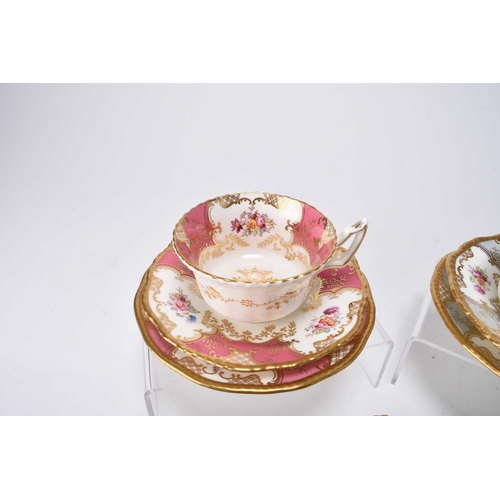 98 - A small group of Coalport batwing teawares, including rarer colourways: a pink trio of teacup, sauce... 