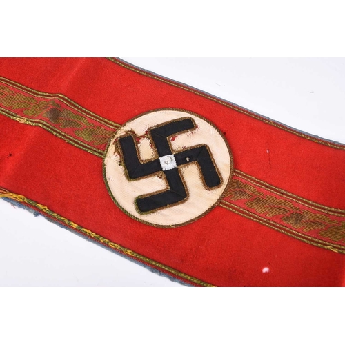 133 - A German Third Reich NSDAP Ortsgruppenleiter Armband (1939-45) constructed of red cotton with a cent... 