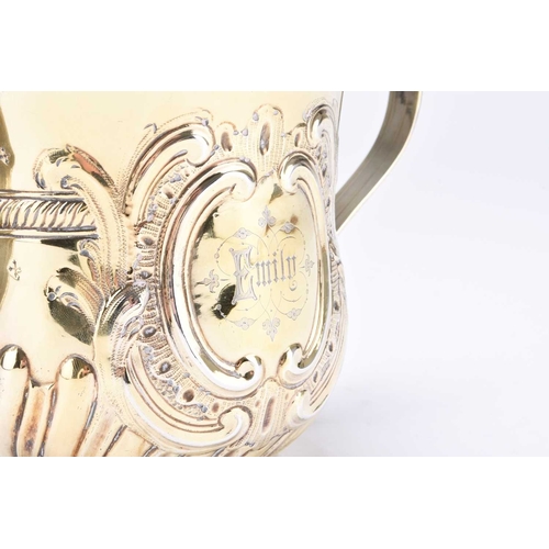 14 - A George II silver gilt porringer, Fuller White, London 1759, of typical form with embossed decorati... 