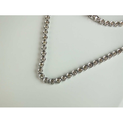 170 - A diamond set necklace, designed as eight-seven brilliant cut diamonds claw set within circular link... 