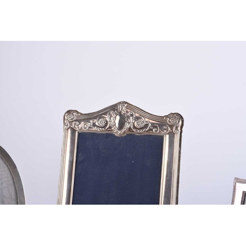 6 - A collection of five silver mounted photograph frames, comprising; a Victorian style rectangular exa... 