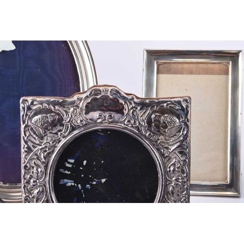 68 - A collection of seven silver mounted photograph frames, comprising; a Victorian style example with c... 