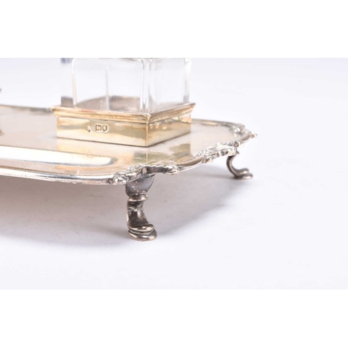 71 - An Edwardian silver inkstand, G*D*, London 1907, of shaped rectangular form with scrolling border an... 