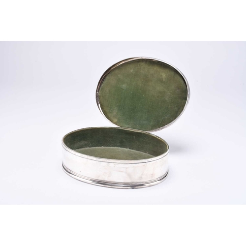 91 - A George V silver mounted oval dressing table box, William Comyns, London 1911, the cover with engin... 