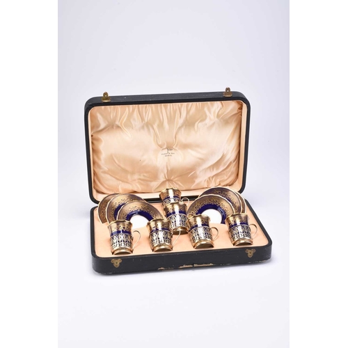 97 - A cased set of silver mounted Coalport coffee cans and sauces, Walker & Hall, Sheffield 1932, presen... 