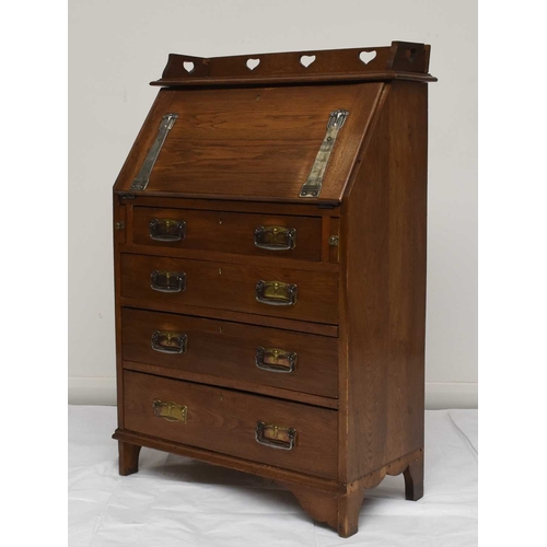 117 - An Art Nouveau style oak bureau desk, the raised back decorated with a heart shaped pierced design o... 