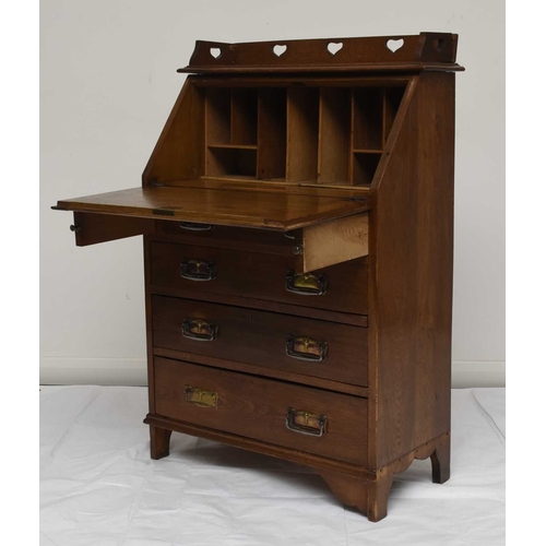 117 - An Art Nouveau style oak bureau desk, the raised back decorated with a heart shaped pierced design o... 