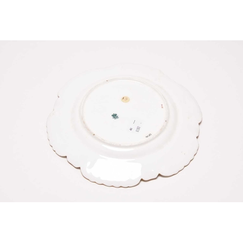 128 - An unusual Coalport plate, circa 1885-90, of circular form with shell-detailed edges in gilt, the ce... 