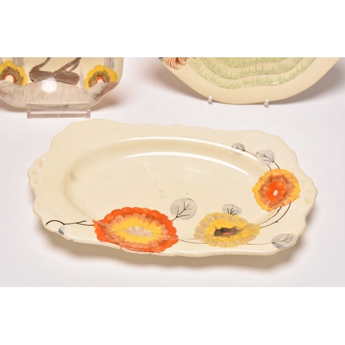 144 - A collection of Clarice Cliff Art Deco ceramics, comprising: A 'Ravel' Odilon circular tureen and co... 