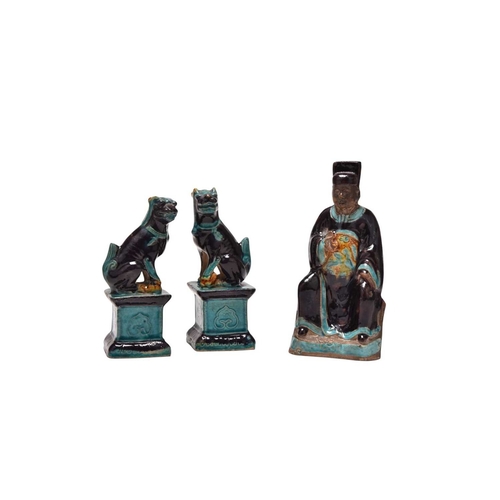 199 - A fahua-glazed figure of a scholar and a pair of Buddhist lions Ming Dynasty The scholar modelled se... 