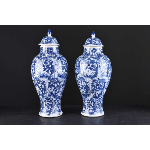 217 - A pair of Chinese transitional blue and white vases and covers, Kangxi Of ovoid form with domed cove... 