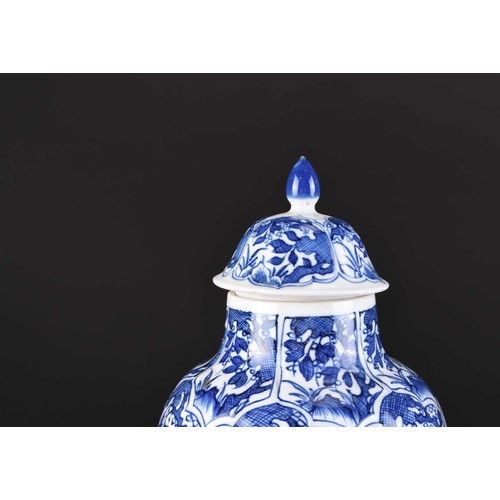 217 - A pair of Chinese transitional blue and white vases and covers, Kangxi Of ovoid form with domed cove... 