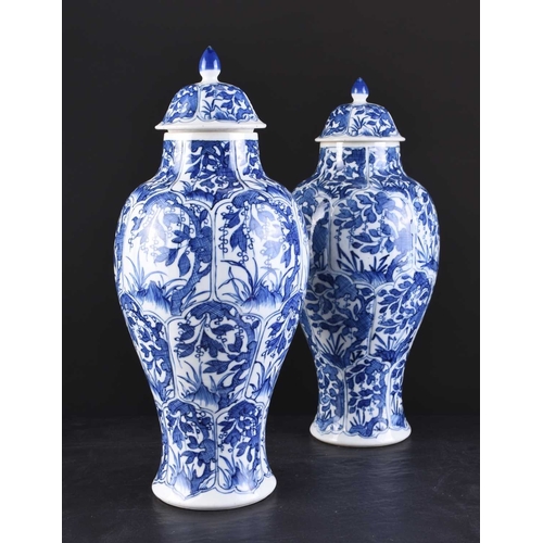 217 - A pair of Chinese transitional blue and white vases and covers, Kangxi Of ovoid form with domed cove... 